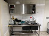 a kitchen with a stainless steel sink and a metal counter