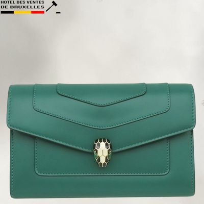 a green purse with a skull on the front of it