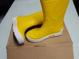 a pair of yellow rain boots on top of a cardboard box