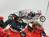 five different models of motorcycles on display on a red platform