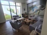 an image of a living room with couches, chairs, and a painting on the wall