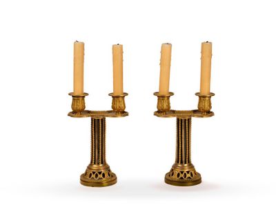pair of antique brass candlesticks on a white background