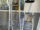two ladders sitting next to each other in a room