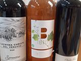 several bottles of wine are lined up on a counter top