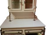 a small cabinet with two open doors on top of it