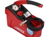 a close up of a red and black air compressor with a hose