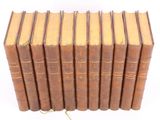 several old books stacked on top of each other on a white surface