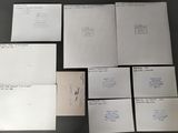 several pieces of white paper sitting on top of a table next to each other
