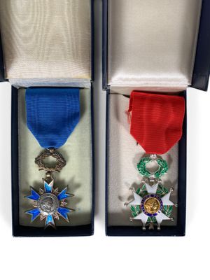 two medals are in a box with a ribbon around them
