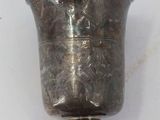 a silver vase that is sitting on a table