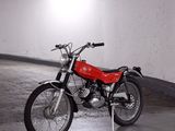 a red motorcycle parked in a parking garage
