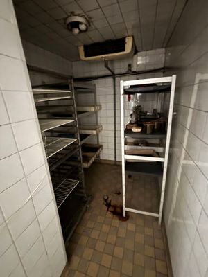 an image of a dirty kitchen with a clock on the wall