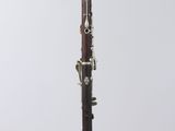 a close up of a clarinet on a clear surface
