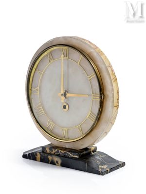une horloge posée sur un socle en marbre