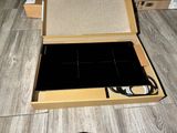 a box with a laptop inside of it sitting on the floor
