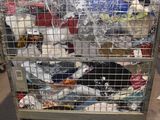 a metal cage filled with lots of items in a warehouse