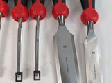 six different types of tools are lined up on a white surface