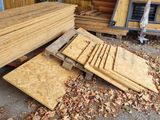 a pile of wood on the ground next to a pile of wood