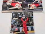 three autocrosse magazine covers on a table with a man in a racing suit