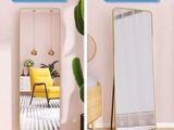 two pictures of a room with a mirror and a yellow chair