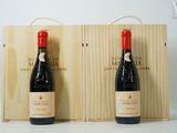 deux bouteilles de vin dans un coffret en bois sur une surface blanche