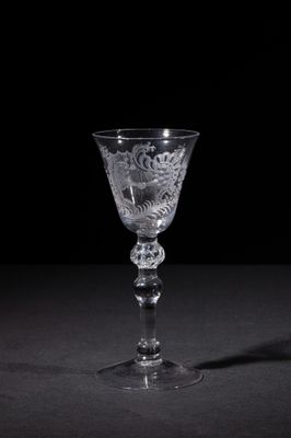 a wine glass that is sitting on a table