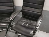 pair of black leather office chairs with chrome legs and arms