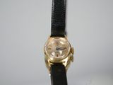 a close up of a watch on a table with a white background
