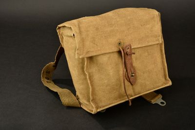 sac à bandoulière en toile et cuir sur fond noir