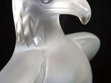 a glass sculpture of a bird on a black background