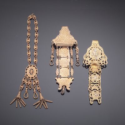 several pieces of jewelry are displayed on a gray surface
