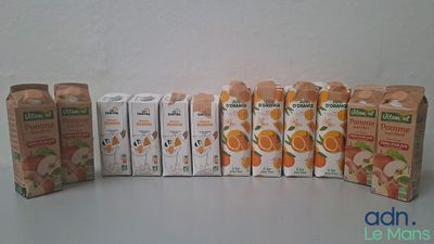 plusieurs cartons de jus d'orange posés les uns à côté des autres sur une table