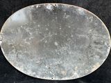 a close up of a metal plate on a black surface