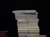 several books stacked on top of each other on a table