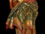 a statue of a man holding a bird in his hand