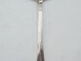 a spoon that has a picture of a man on it