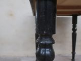 a black table with a wooden top and black legs