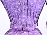 purple dress with white paisley pattern on the back and neck