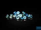 a bunch of blue and white diamonds on a black surface