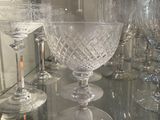 a glass shelf with a lot of wine glasses on it