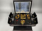 a black box with gold and silver items inside of it