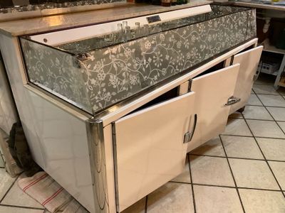 a kitchen that has a stove and a sink in it