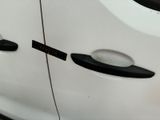 a close up of a car door handle with a sticker on it