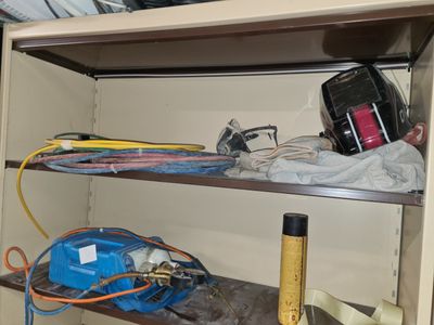 une étagère sur laquelle sont posés de nombreux câbles et outils