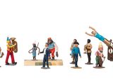 many figurines of different people standing in a line