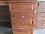 a tall wooden dresser with drawers in a room
