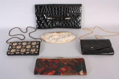 four purses and a purse chain on a white surface
