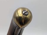 a close up of a metal object with a bird on it ' s head
