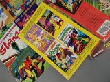 a lot of comic books on the table together