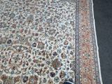 a person standing on the floor next to a rug